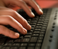Hands typing at keyboard.